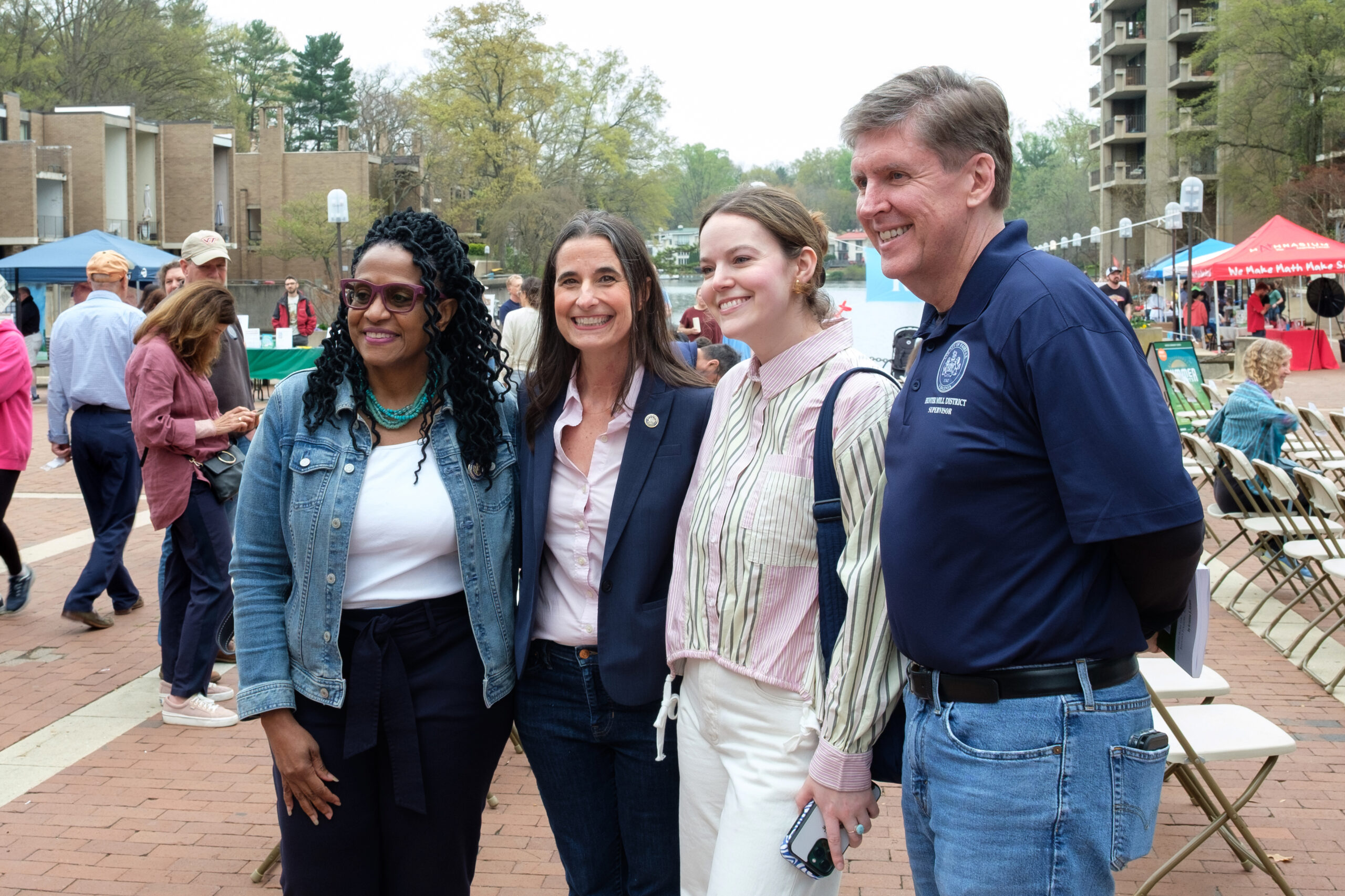 Group of people smiling together at an outdoor community event in Reston.