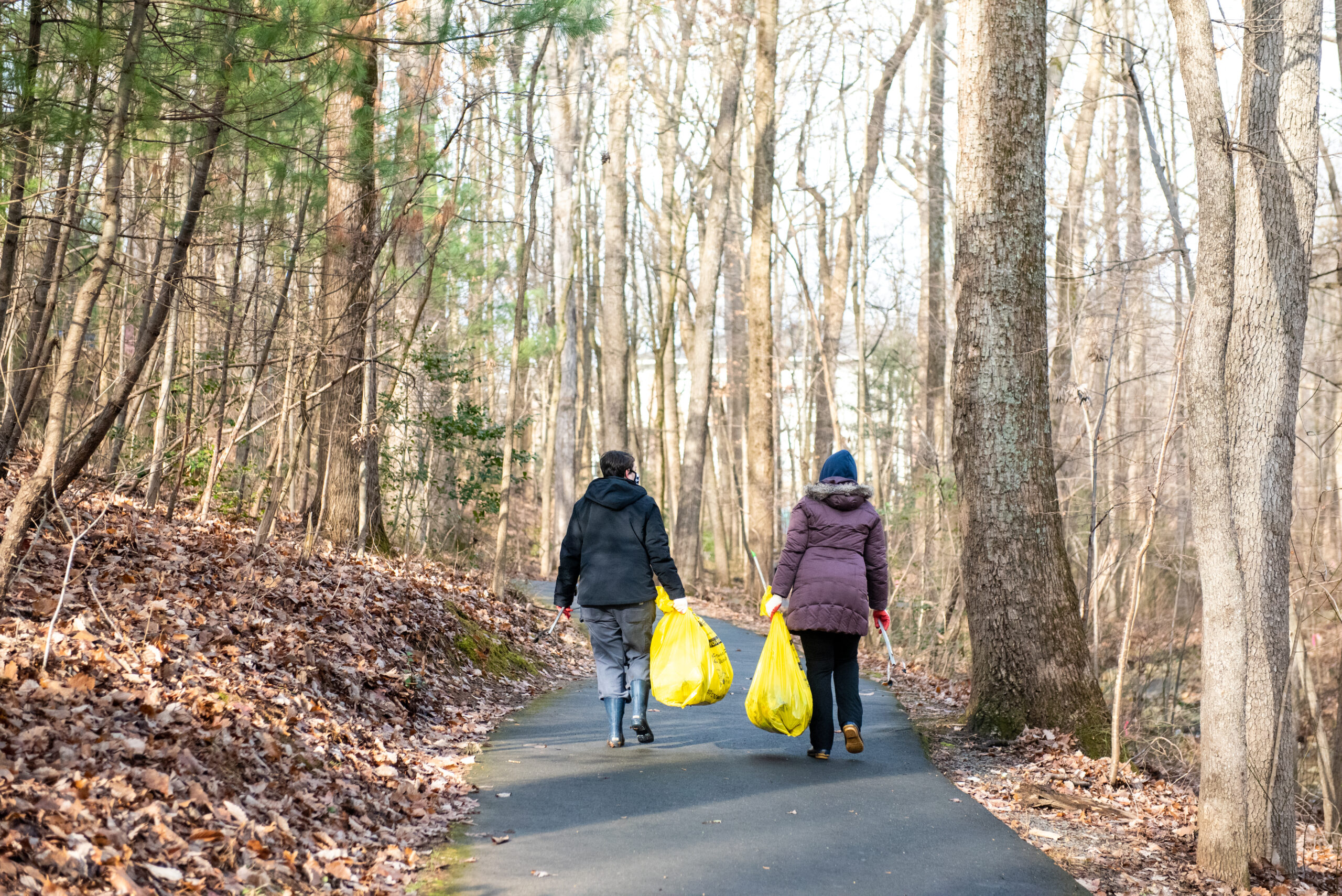 Two people walking after cleaning up the trail