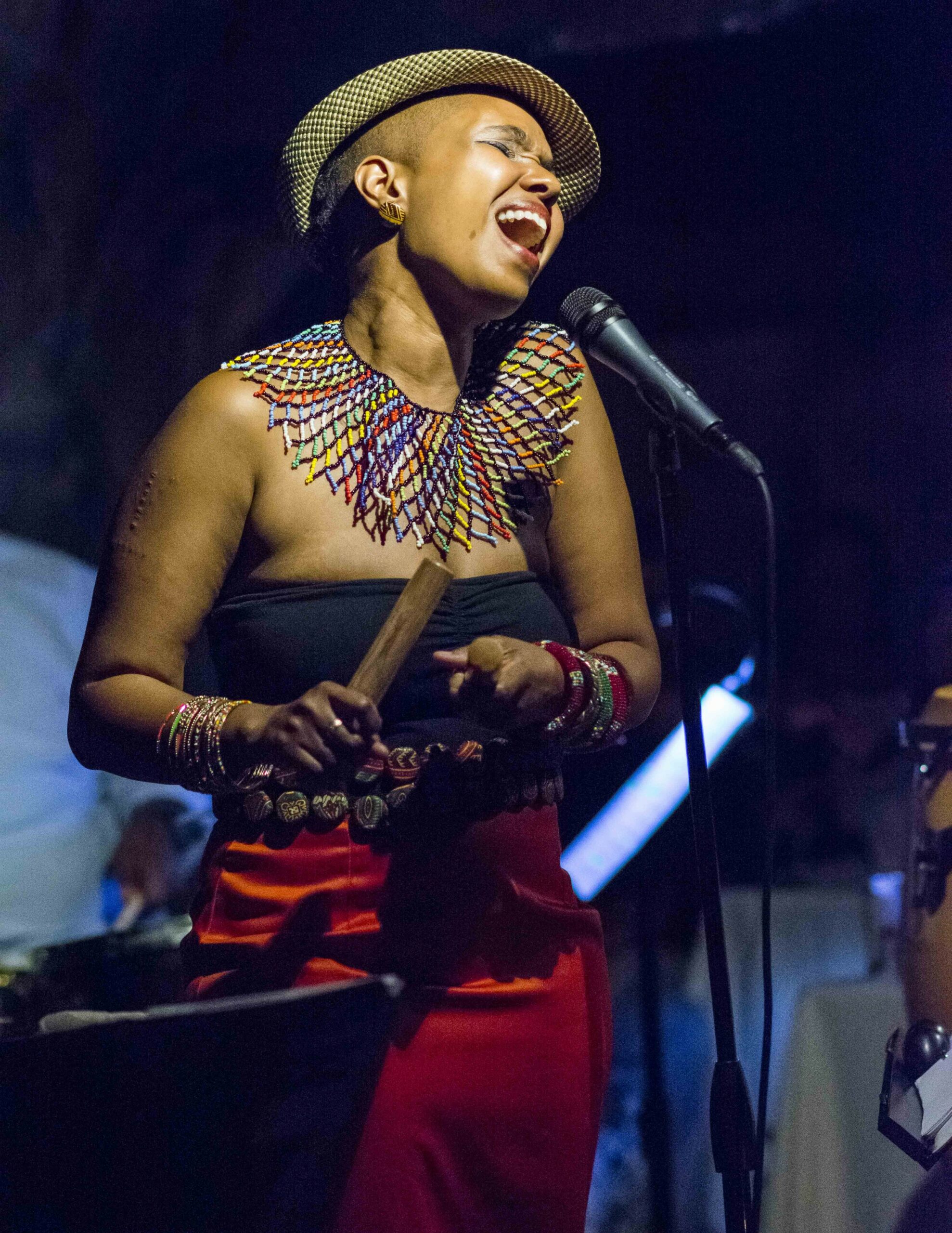 Singer performing passionately on stage with a microphone.