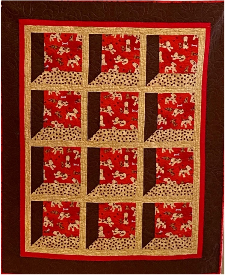 Red and brown quilt featuring a repeating dog pattern.