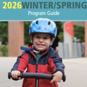Little boy on a bike on the cover page of the Winter Spring Guide